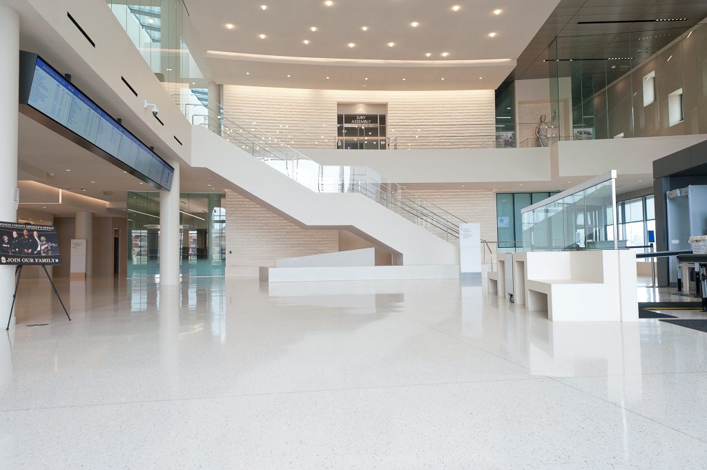 Overview image of the side of the large white stairs with glass siding and silver railings.