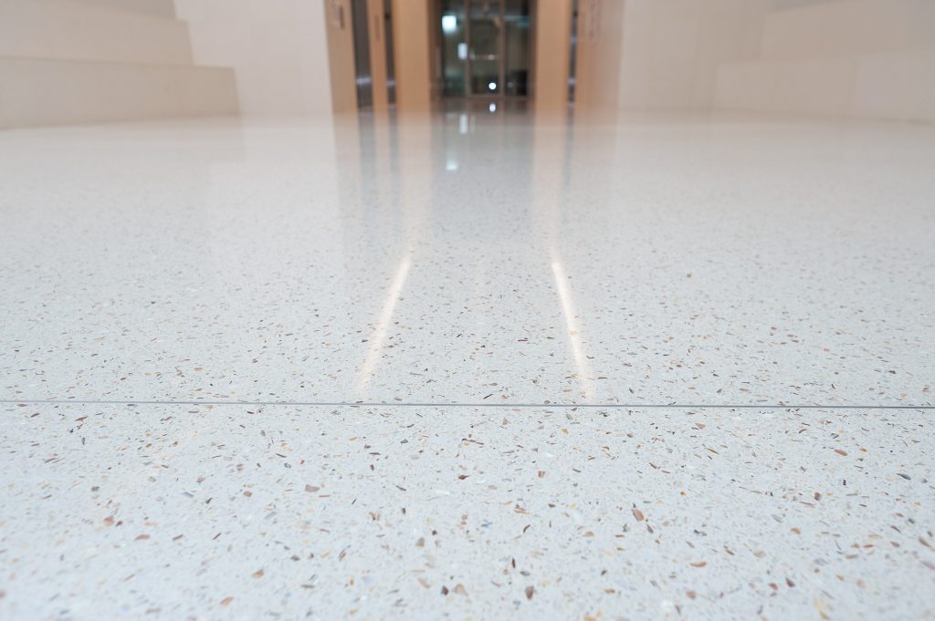 Close up image of a glossy white speckled floor.