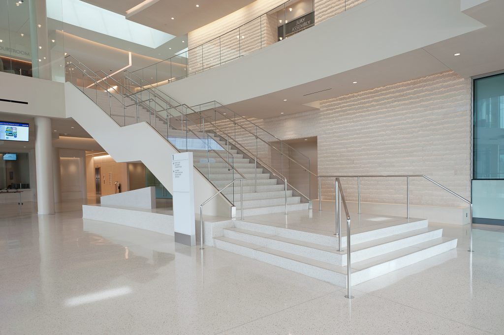 Image of beautiful white stairs with glass siding and silver rails.